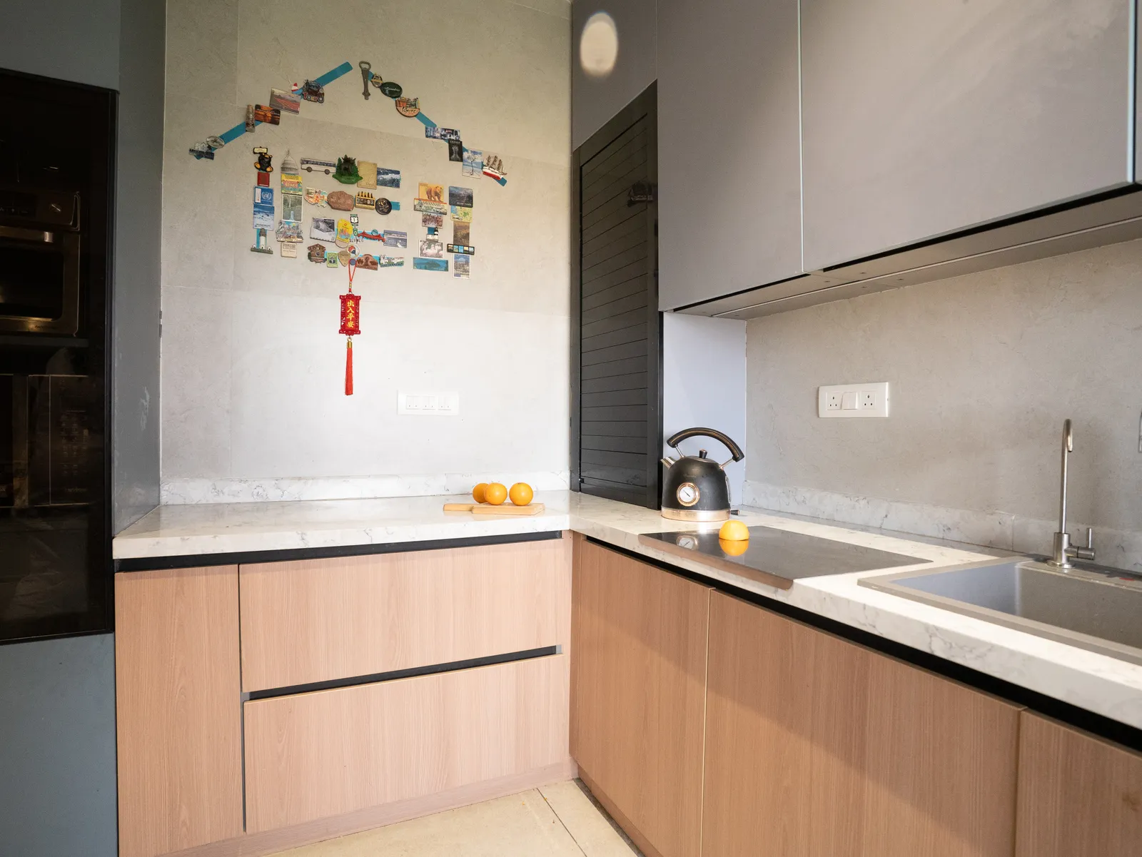 L-shaped kitchen with oak base cabinets and grey uppers — Amlan's Residence